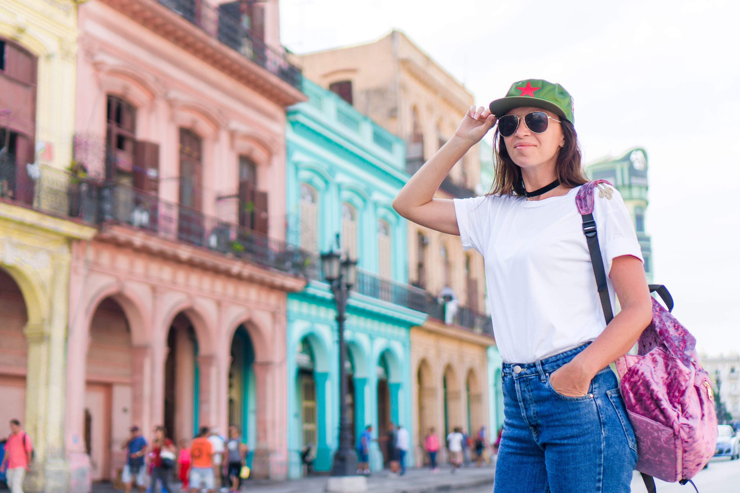 Tourist girl in popular area in Havana, Cuba. Young woman traveler smiling